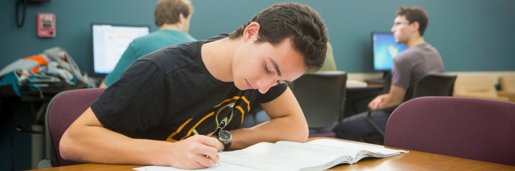 Student studies at desk at Loyola Marymount University.